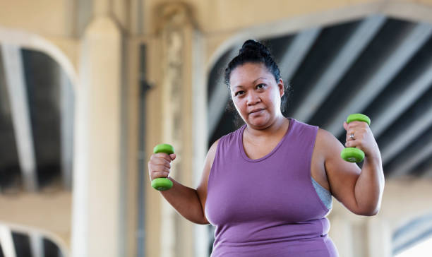 istock Pacific Islander woman exercising with dumbbells 1383691959