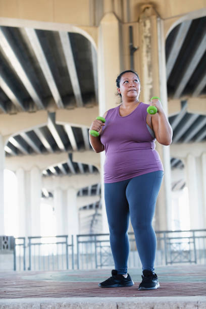 istock Pacific Islander woman exercising with dumbbells 1383691970