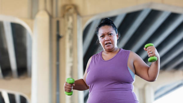 istock Pacific Islander woman exercising with dumbbells 1383691973