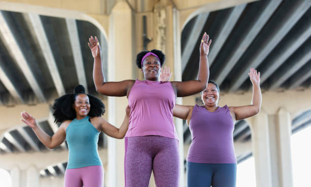 istock Three multiracial women doing jumping jacks 1383691986