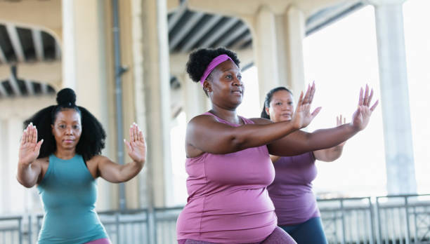 istock Three multiracial women practicing tai chi in urban area 1383692011