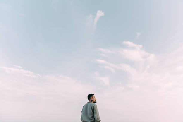 istock Young woman looking up at view 1383701542