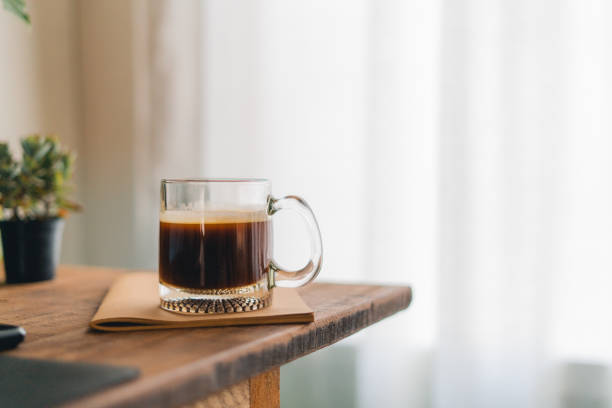 istock Coffee Morning,Coffee in a mug on a wooden table with a notebook 1383711870