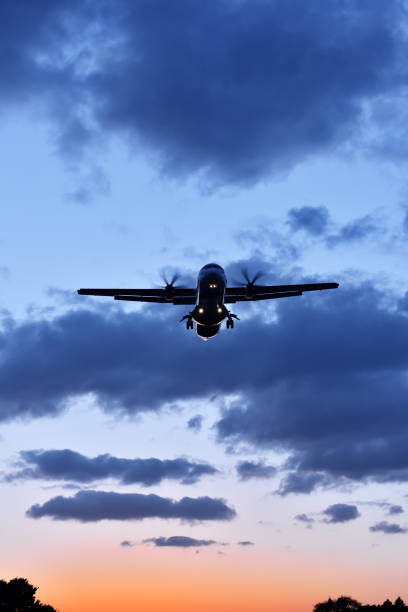 istock A plane landing at sunset 1383715186