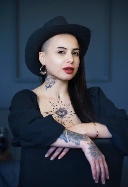 Female Tattoo artist posing in studio stock photo
