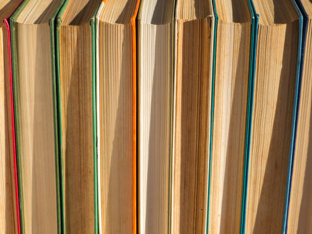 istock Old, battered and faded hardcover books or textbooks in a bookstore or library. A stack of hardcover Books. The concept of 