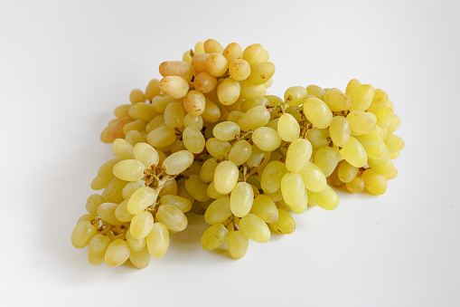 Yellow oval shaped grapes on white background, organic food, studio shot