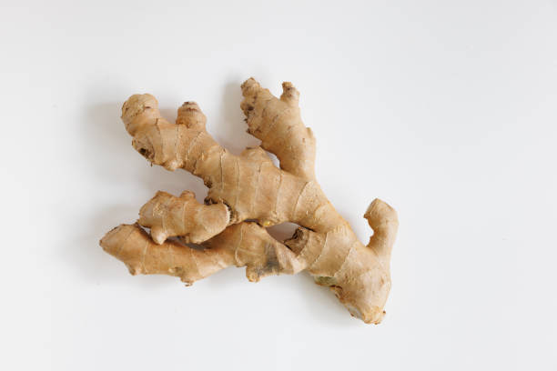 Ginger root on white background Whole ginger root on white background, organic food, studio shot directly above ginger stock pictures, royalty-free photos & images