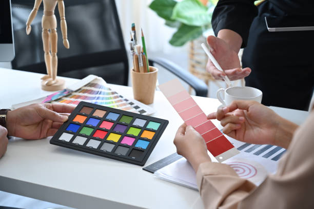istock Creative people using color swatches and working together in design studio. 1383733800