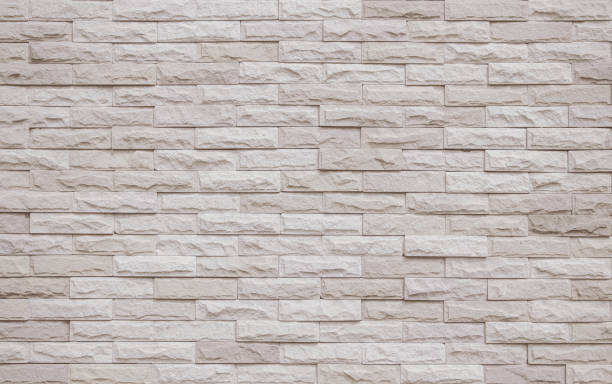 istock Cream and beige brick wall texture background. Brickwork and stonework flooring interior rock old pattern clean concrete grid uneven bricks office design. Background of old vintage brick wall backdrop 1383744473