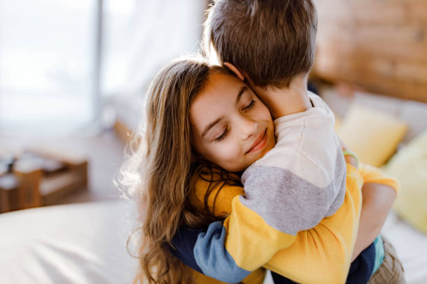 istock Loving little siblings embracing at home. 1383754480