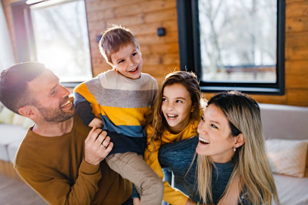 istock Cheerful family having fun while playing on sofa in the living room. 1383755026