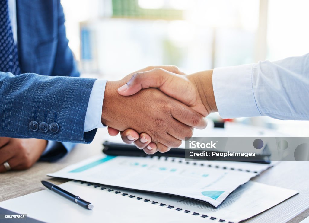 Shot of two unrecognizable businessmen shaking hands in a office Men who do not plan long ahead will find trouble Agreement Stock Photo