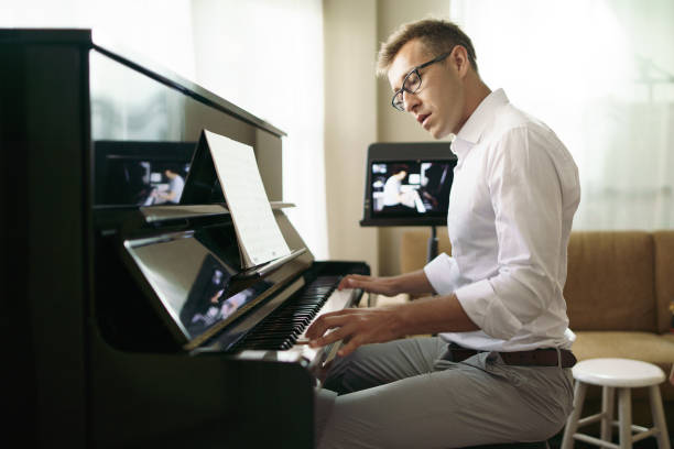 istock Scene of piano lessons online training or E-class learning while Coronavirus spread out or covid-19 crisis situation, vlog or teacher make online piano lesson to teach students pupils learn from home. 1383761115