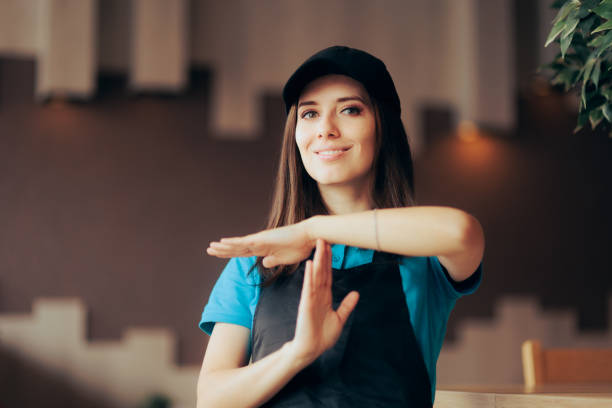 Fast Food Employee Making a Break Time Gesture Restaurant worker asking for no more overtime schedule restaurant labor union stock pictures, royalty-free photos & images