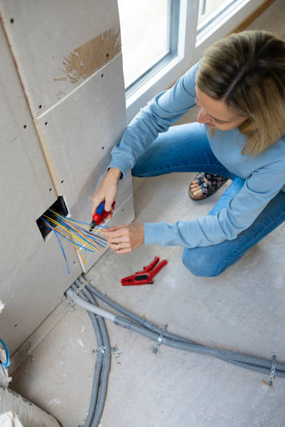 istock young woman working on electrics on construction site at an attic renovation 1383780787