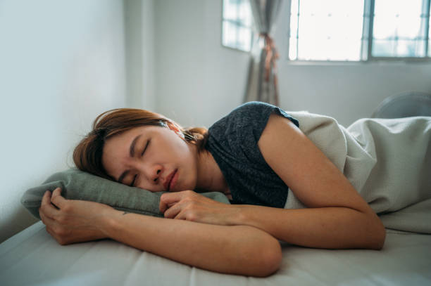 istock An Asian woman sleeping under blanket at bedroom 1383803605