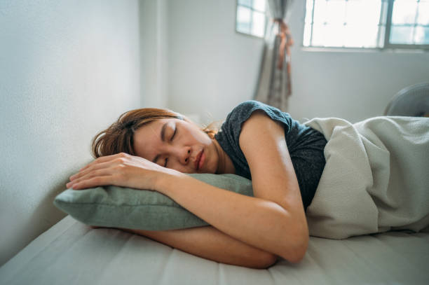 istock An Asian woman sleeping under blanket at bedroom 1383803687