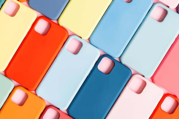 pattern of bright multicolored plastic smartphone cases stock photo