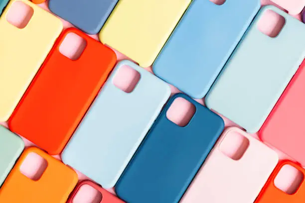 Photo of pattern of bright multicolored plastic smartphone cases