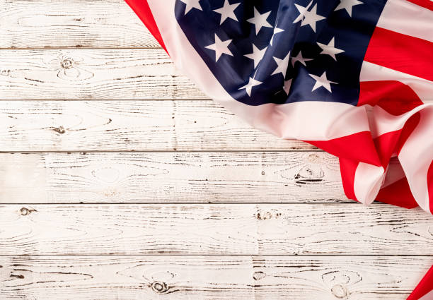istock USA national flag on white wooden background 1383811708