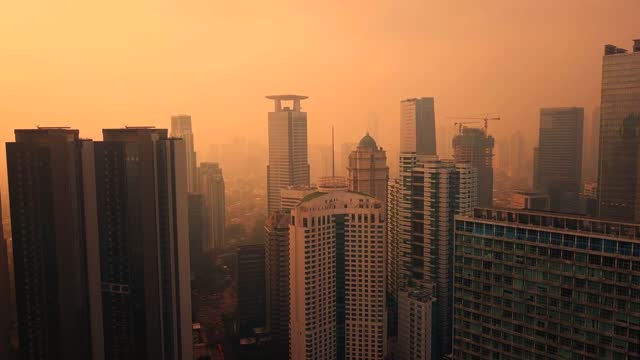 Jakarta city with orange sky and fog