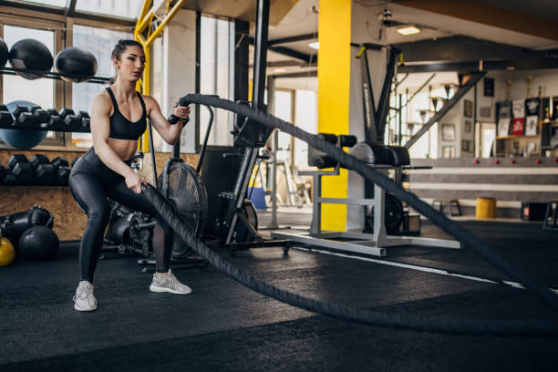istock Woman training with battle ropes 1383816295