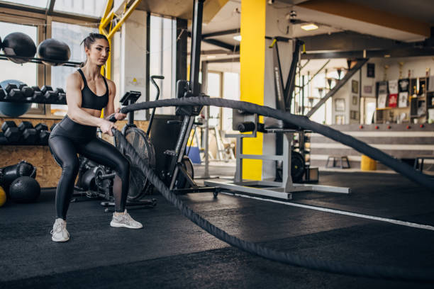 istock Woman training with battle ropes 1383816315