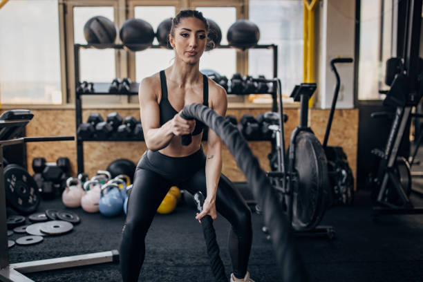 istock Woman exercising with battle ropes 1383816385