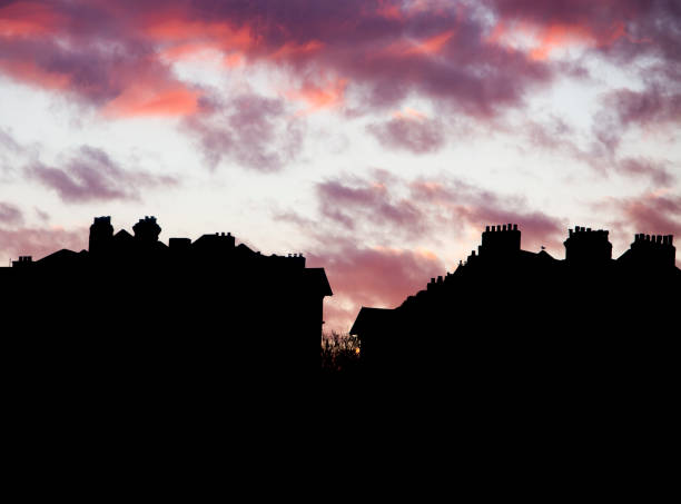 istock Red sunrise above silhouetted rooftops 1383816766