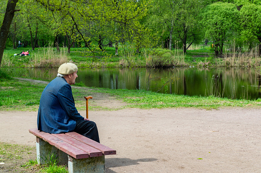 Saint Petersburg, Russia - 17 May 2021. an elderly man on a park bench