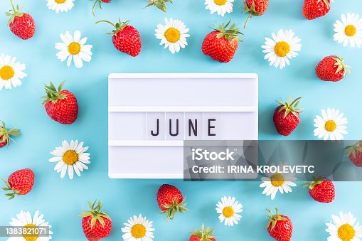 istock Summer month June text on light box and strawberry, chamomile flowers on blue background. Top view Flat lay. Creative concept Hello June. Top view, Flat lay, greeting card 1383821071