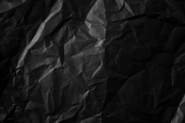 istock Textured crumpled black paper background. 1383823534