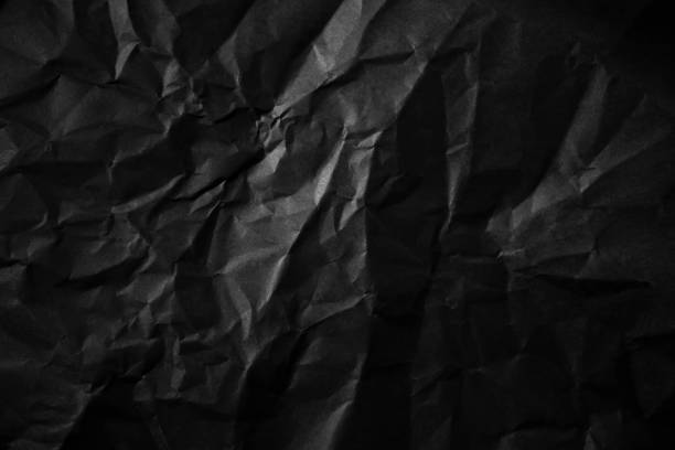 istock Textured crumpled black paper background. 1383823543
