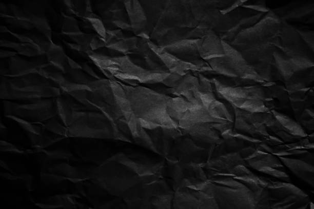 istock Textured crumpled black paper background. 1383823563