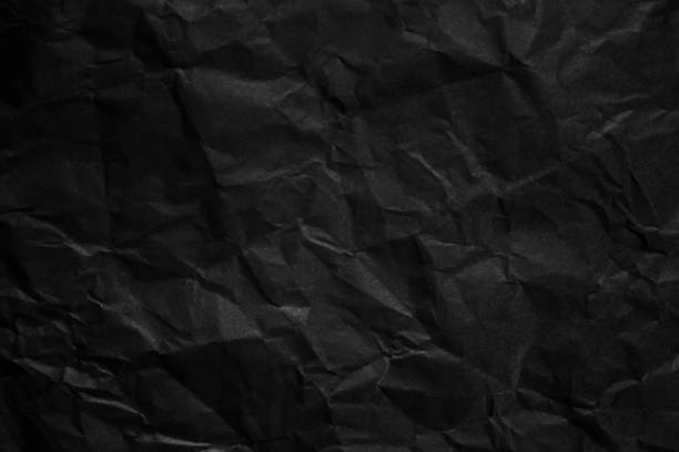 istock Textured crumpled black paper background. 1383823582
