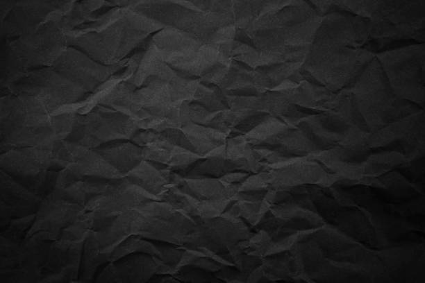 istock Textured crumpled black paper background. 1383823583