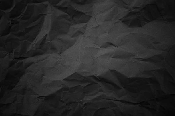 istock Textured crumpled black paper background. 1383823612
