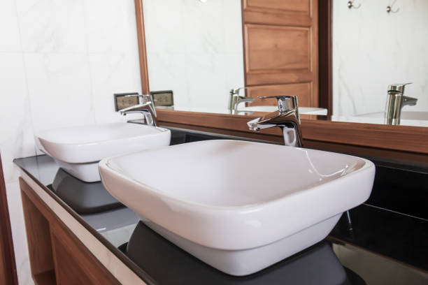 Bathroom faucets in a row.