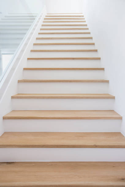 istock Wooden stairs with clean white walls. 1383823745