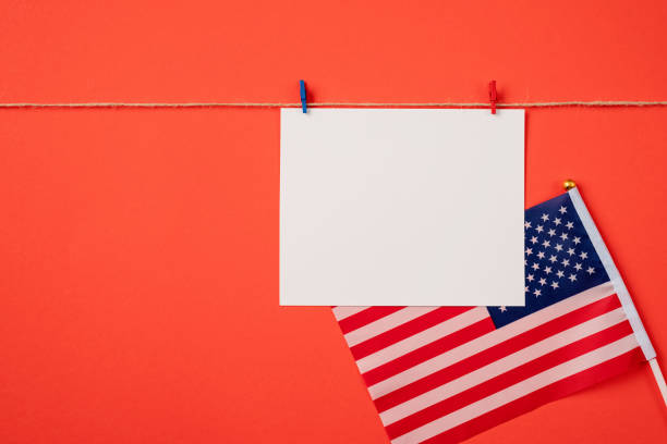 istock Blank white paper for mockup design with red and blue clips on red background 1383824746