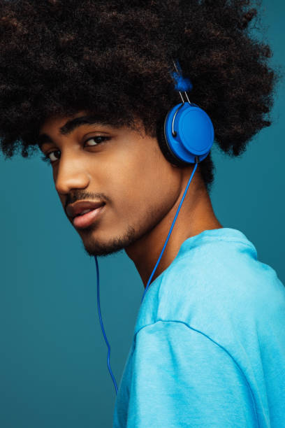 istock African american man with african hairstyle using phone 1383826432
