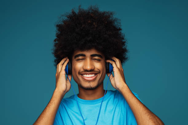 istock African american man with african hairstyle using phone 1383826576