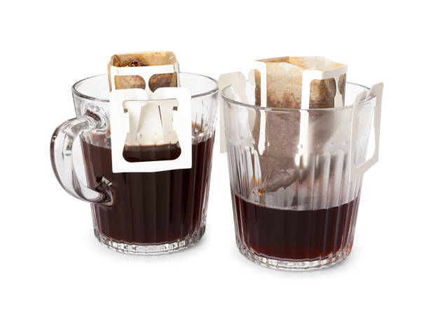 istock Glass cups with drip coffee bags isolated on white 1383828003