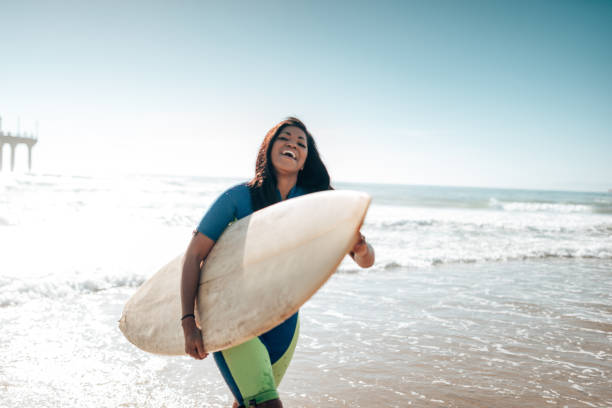 istock surfer woman on manhattan beach pier 1383832215