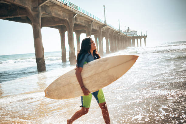 istock surfer woman on manhattan beach pier 1383832353