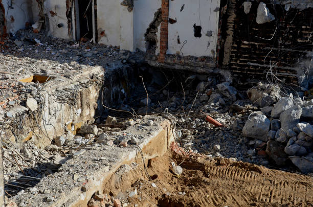 istock demolition of an apartment building worker on a forklift using a jackhammer. creates an apocalyptic scene. clearing work after the bombing. reconstruction of the historic castle building 1383833572