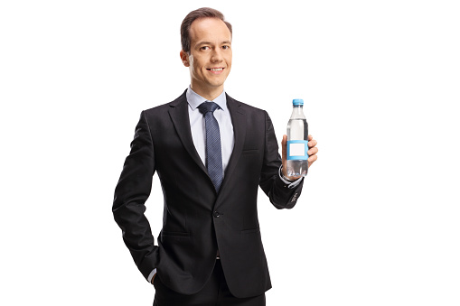 Businessman holding a bottle of water isolated on white background