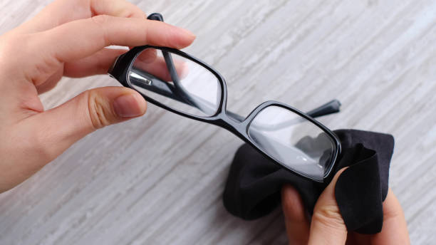 istock Cleaning a pair of dirty eye glasses with a microfiber 1383835493
