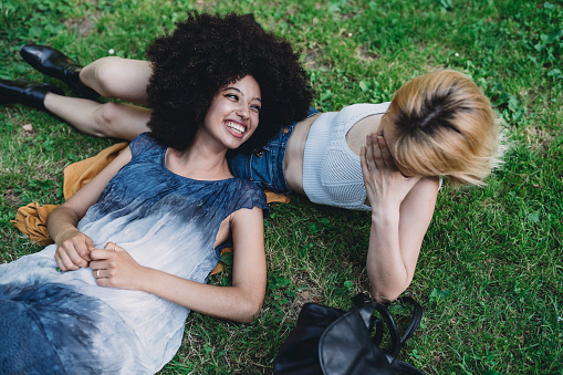 Two young adult women together at the park